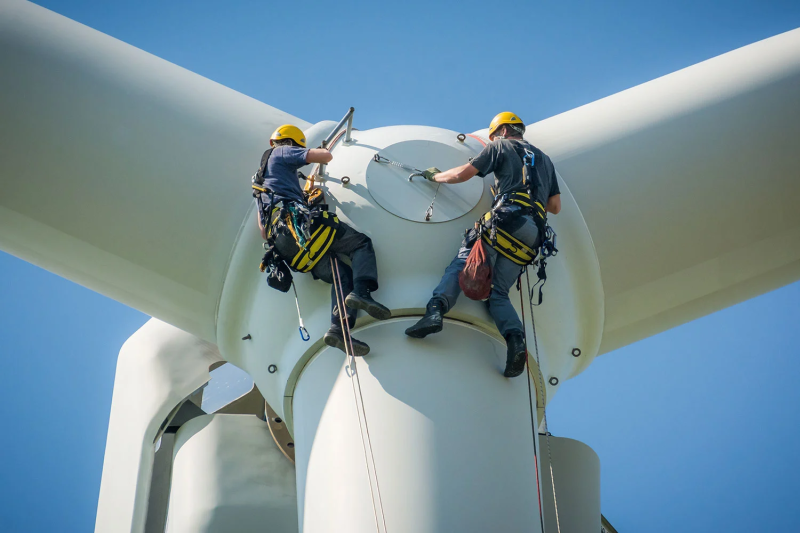 Inspection-engineers-preparing-to-rappel-down-a-rotor-blade-of-a-wind-turbine