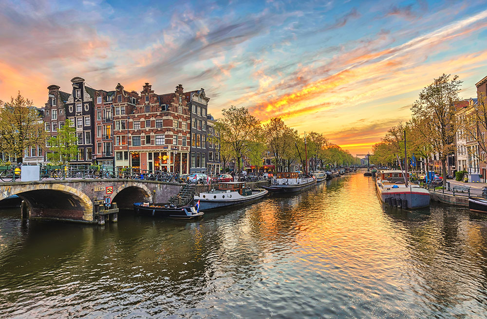 Amsterdam-sunset-city-skyline-at-canal-waterfront