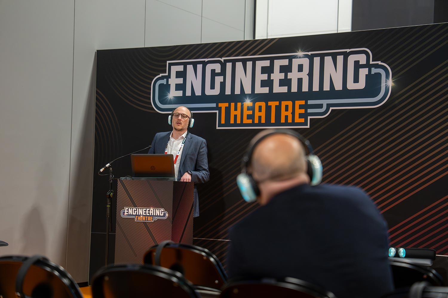 ET area presenter behind lecturn looking at listeners